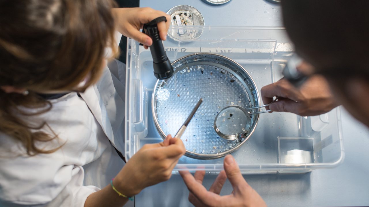 The Ocean Cleanup research team processes ocean plastic samples in the laboratory.