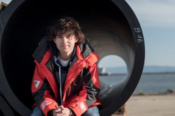 Boyan Slat sits in a floater segment of the first cleanup system on the assembly yard, April 2018.