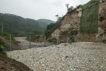 Interceptor 006 in Las Vacas river, Guatemala, during the start of the flash flood. The Ocean Cleanup's first Interceptor Trashfence, piloted in May/June 2022