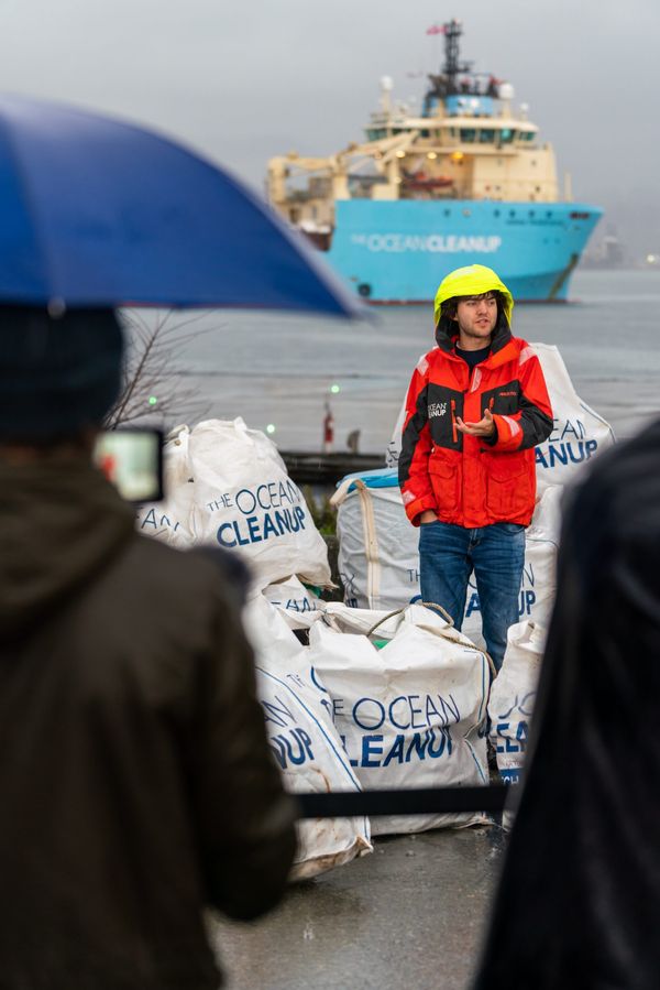 Boyan Slat standing with first plastic catch onshore at end of the System 001/B testing. The press conference was in Vancouver, Canada, in December 2019.