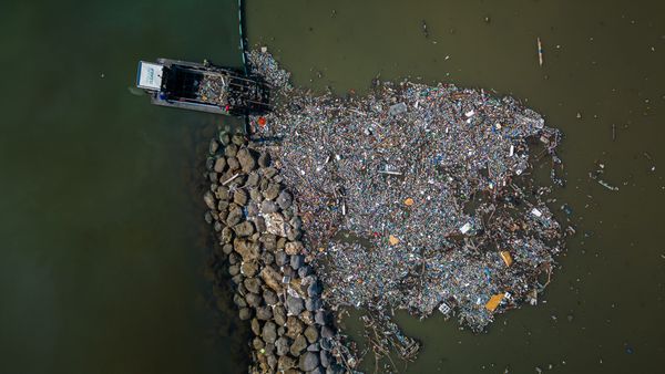 Aerial footage of the Interceptor Tender extracting intercepted plastic