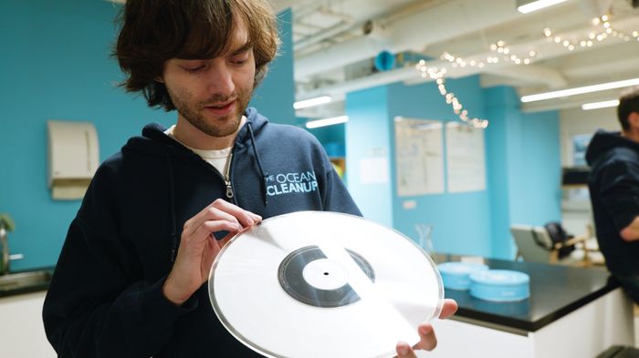 Boyan Slat, founder and CEO of The Ocean Cleanup, holding a sample LP