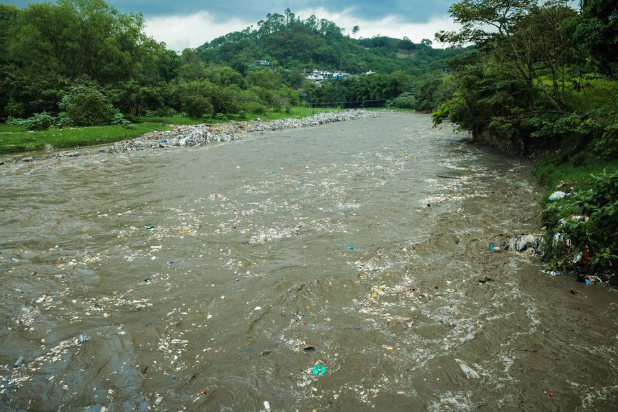 River with a lot of plastic flowing downstream